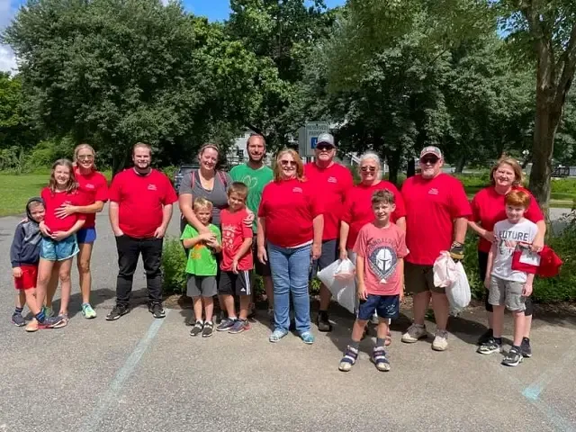 Volunteers and children in matching red T-shirts